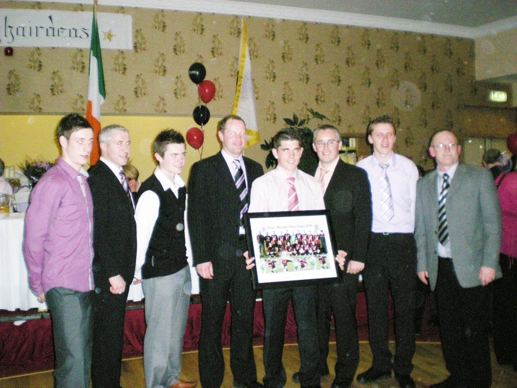 Ronan receiving his presentation from the Club with L/R Thomas Duffy, Stephen Carolan, Sean Gaughan, Eric O'Reilly, Harry Reilly, Tom McAndew and Tom Reilly.